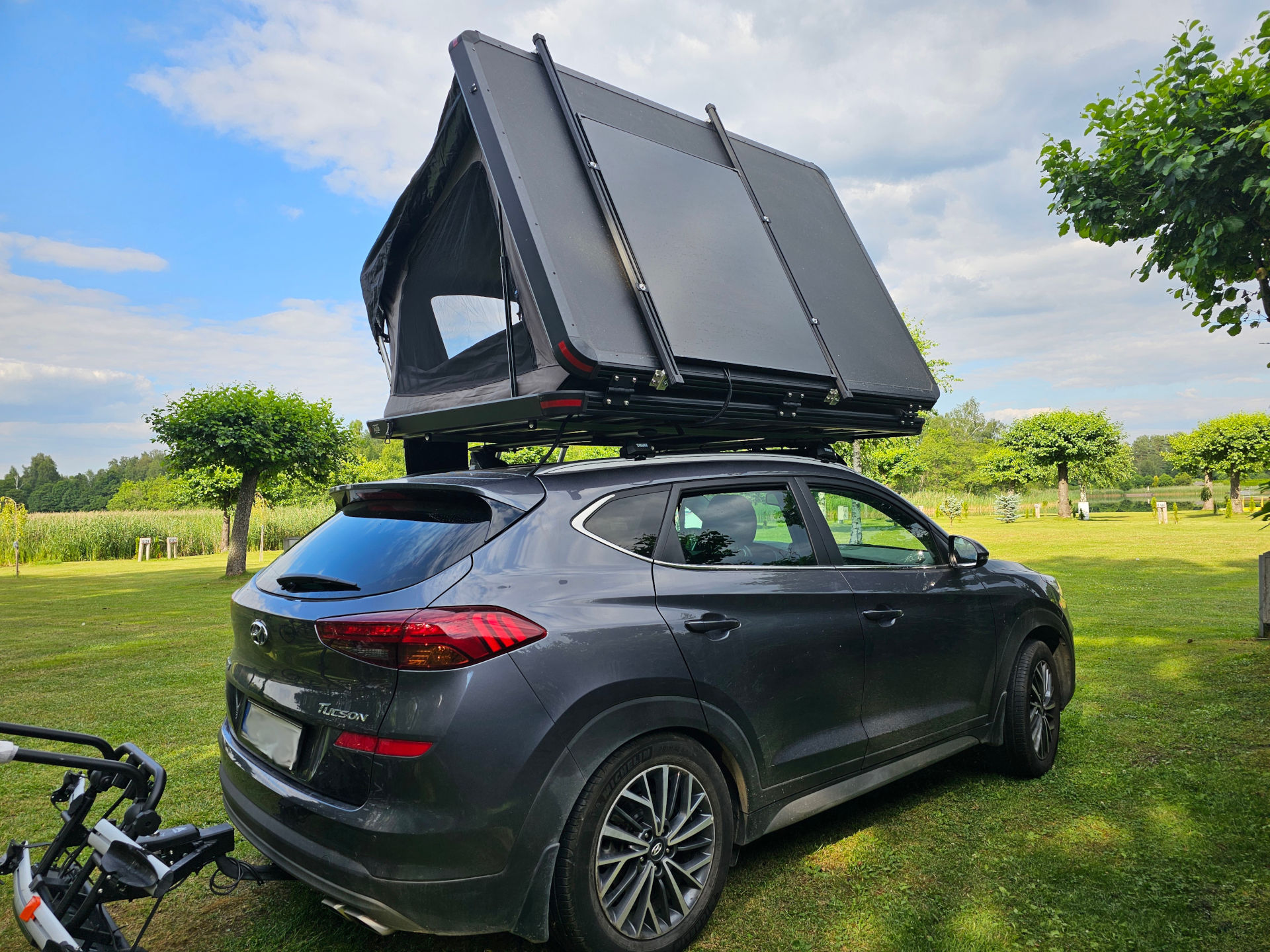 Solar panel permanently mounted on the closed Wild Land rooftop tent.