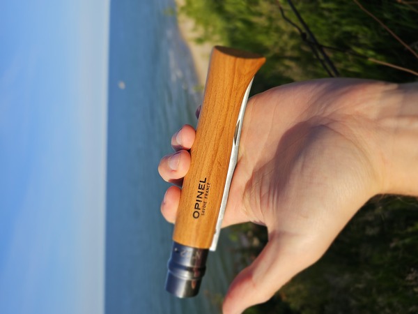 A classic French Opinel folding knife with a wooden handle.