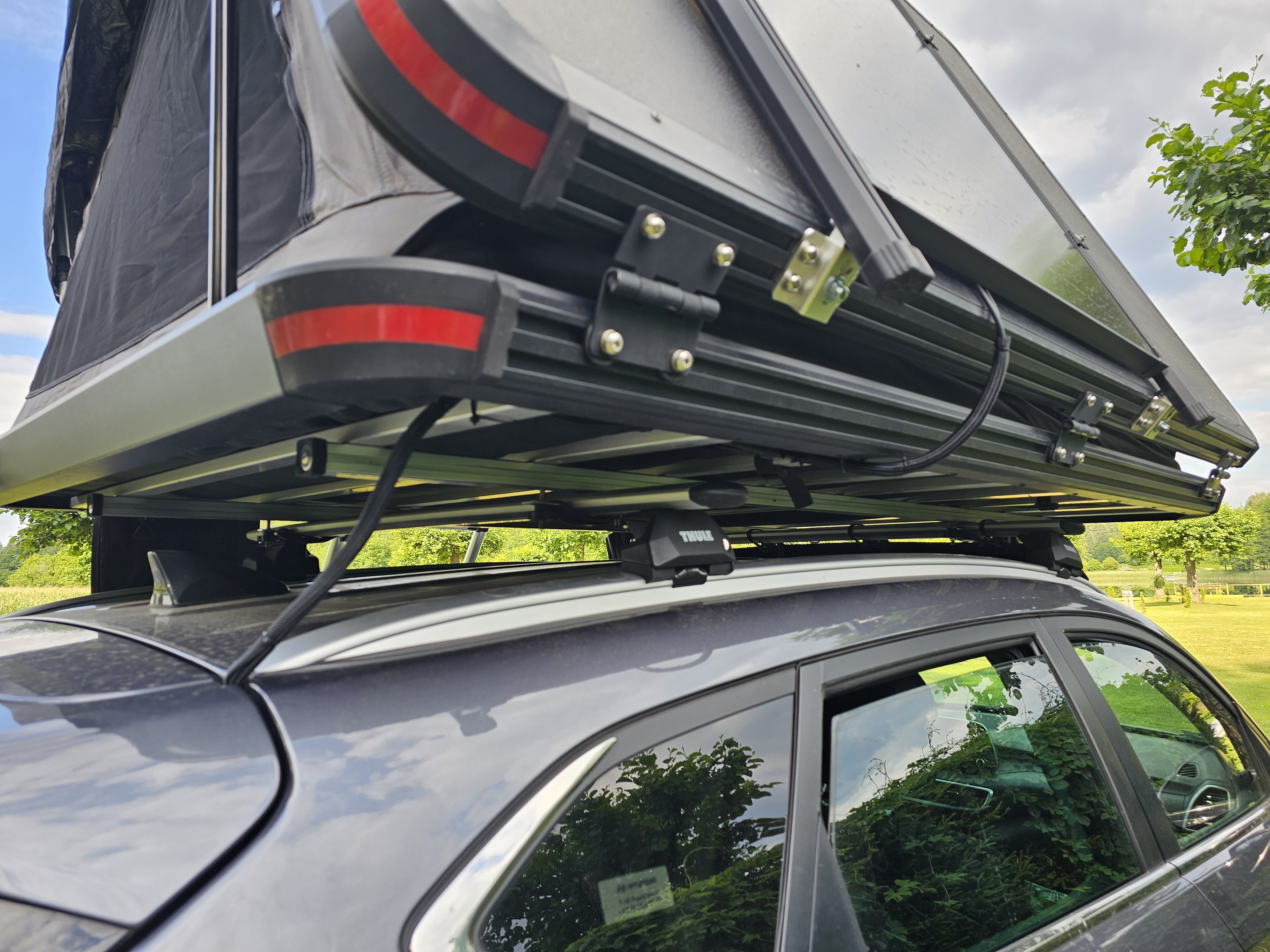 A view from underneath the deployed rooftop tent, showing its support structure.