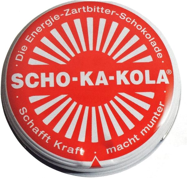 The iconic round, metal tin of Scho-ka-kola chocolate.